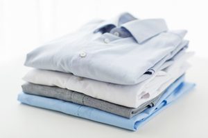 close up of ironed and folded shirts on table